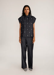ROSANI The Converis shirt in charcoal - charcoal denim sleeveless shirt with metal flower embroidery, front view