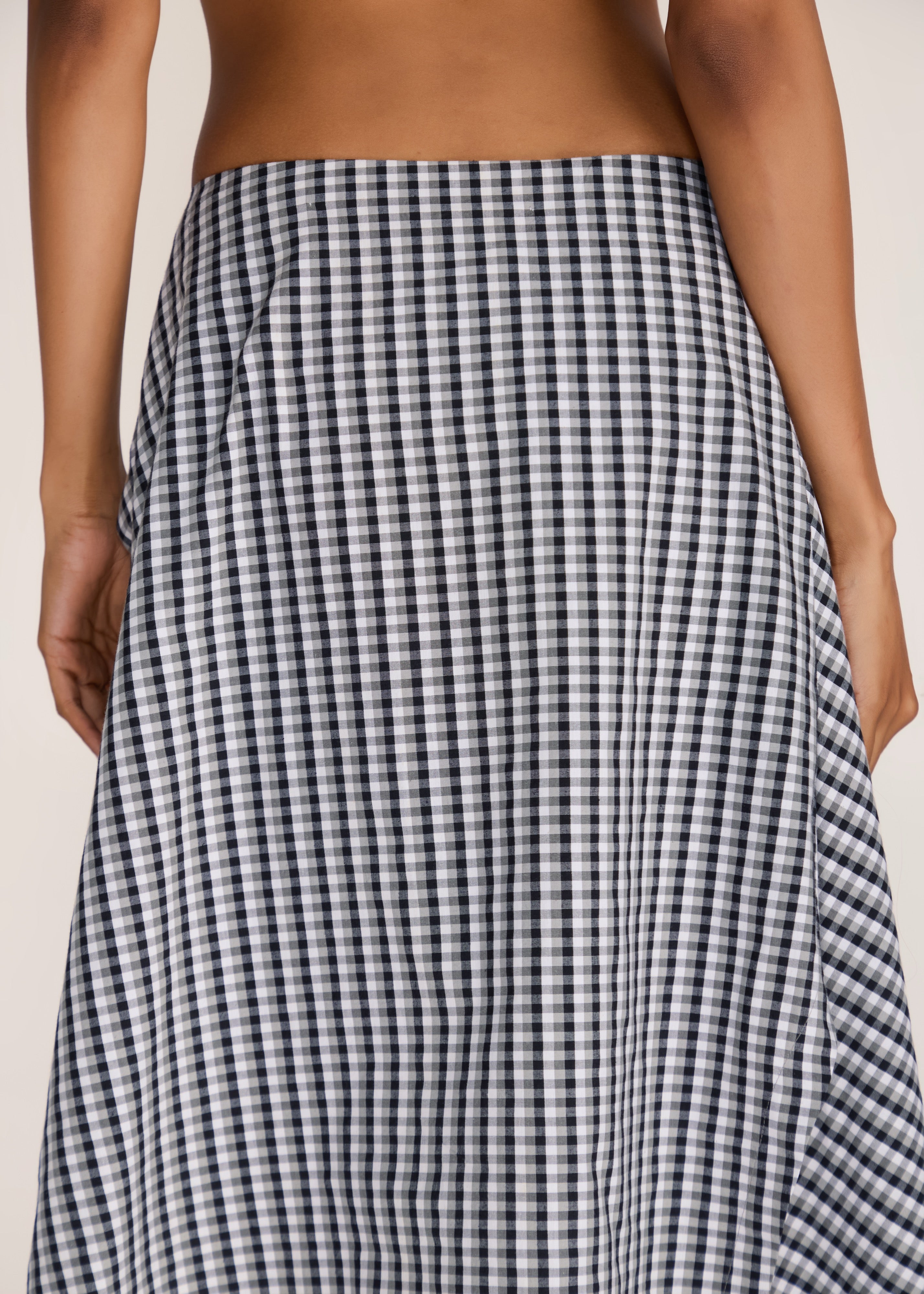 ROSANI The Onda skirt in grey stripes - grey striped wave-inspired overlay skirt with belt detail, back view