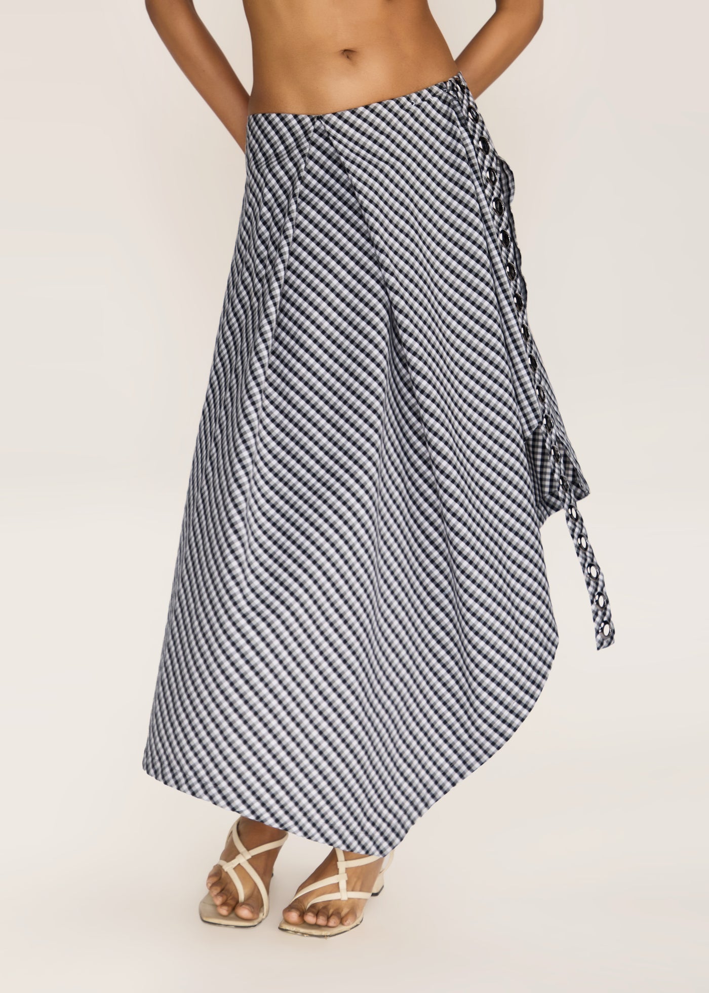 ROSANI The Onda skirt in grey stripes - grey striped wave-inspired overlay skirt with belt detail, front view