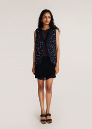 ROSANI The Synra vest in black denim - black denim eyelet and button embroidered vest, front view