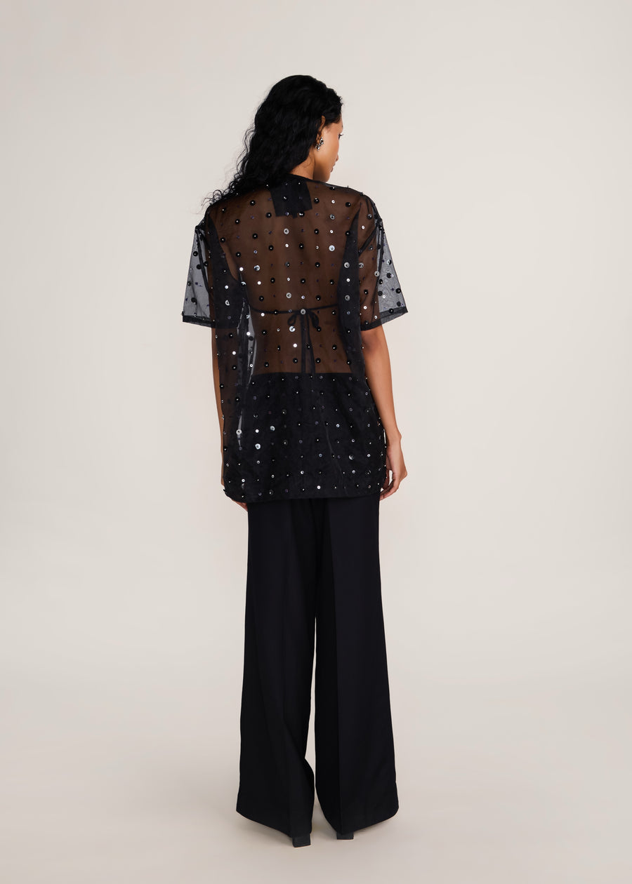 ROSANI The Zephyr tunic in black - black crisp organza tunic with sequin and metallic accents, back view