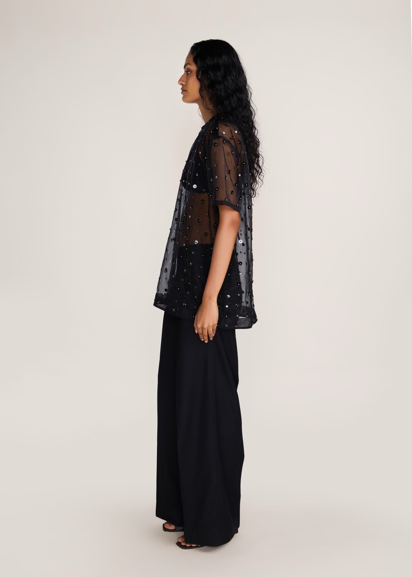 ROSANI The Zephyr tunic in black - black crisp organza tunic with sequin and metallic accents, side view