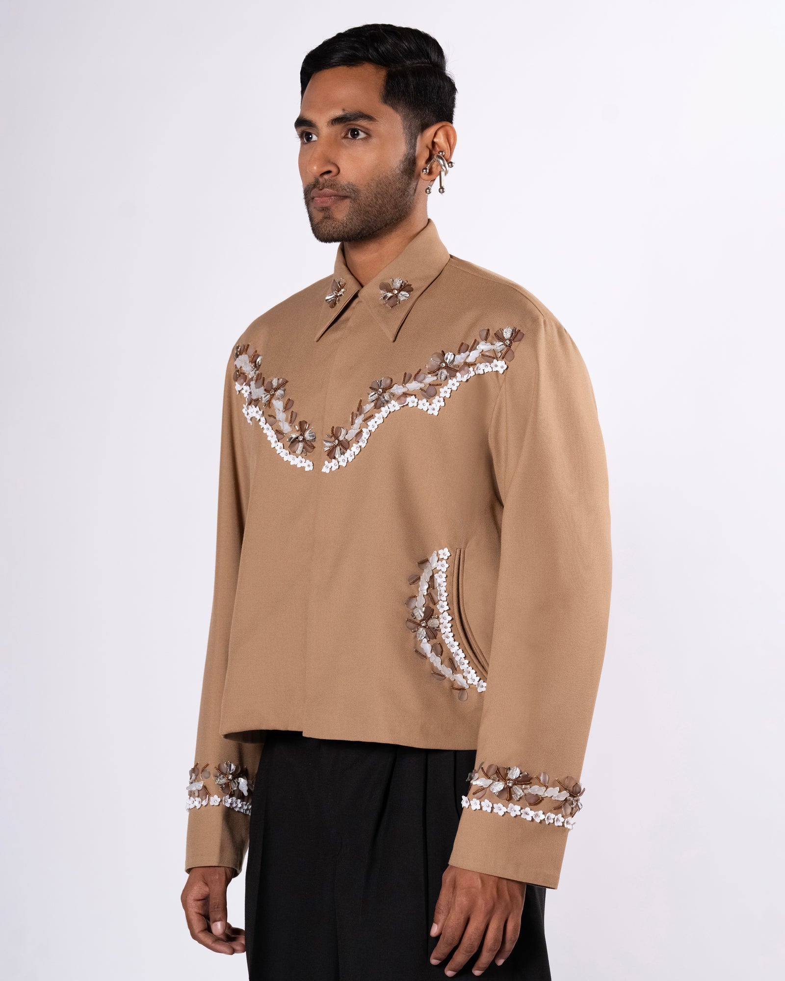 ROSANI The Darby jacket in khaki. Relaxed cowboy-inspired jacket with acrylic floral embellishment and magnetic button closure. ANIMA and ANIMUS collection, front view.