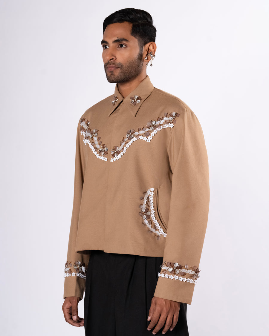 ROSANI The Darby jacket in khaki. Relaxed cowboy-inspired jacket with acrylic floral embellishment and magnetic button closure. ANIMA and ANIMUS collection, front view.