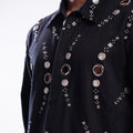 ROSANI The Arnos jacket, detail view of hand-placed metallic eyelets and magnetic press button embellishment.