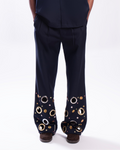 ROSANI The Aryom trouser in blue, front view. Wide-leg with metallic ring embellishment. DYMENSION collection.