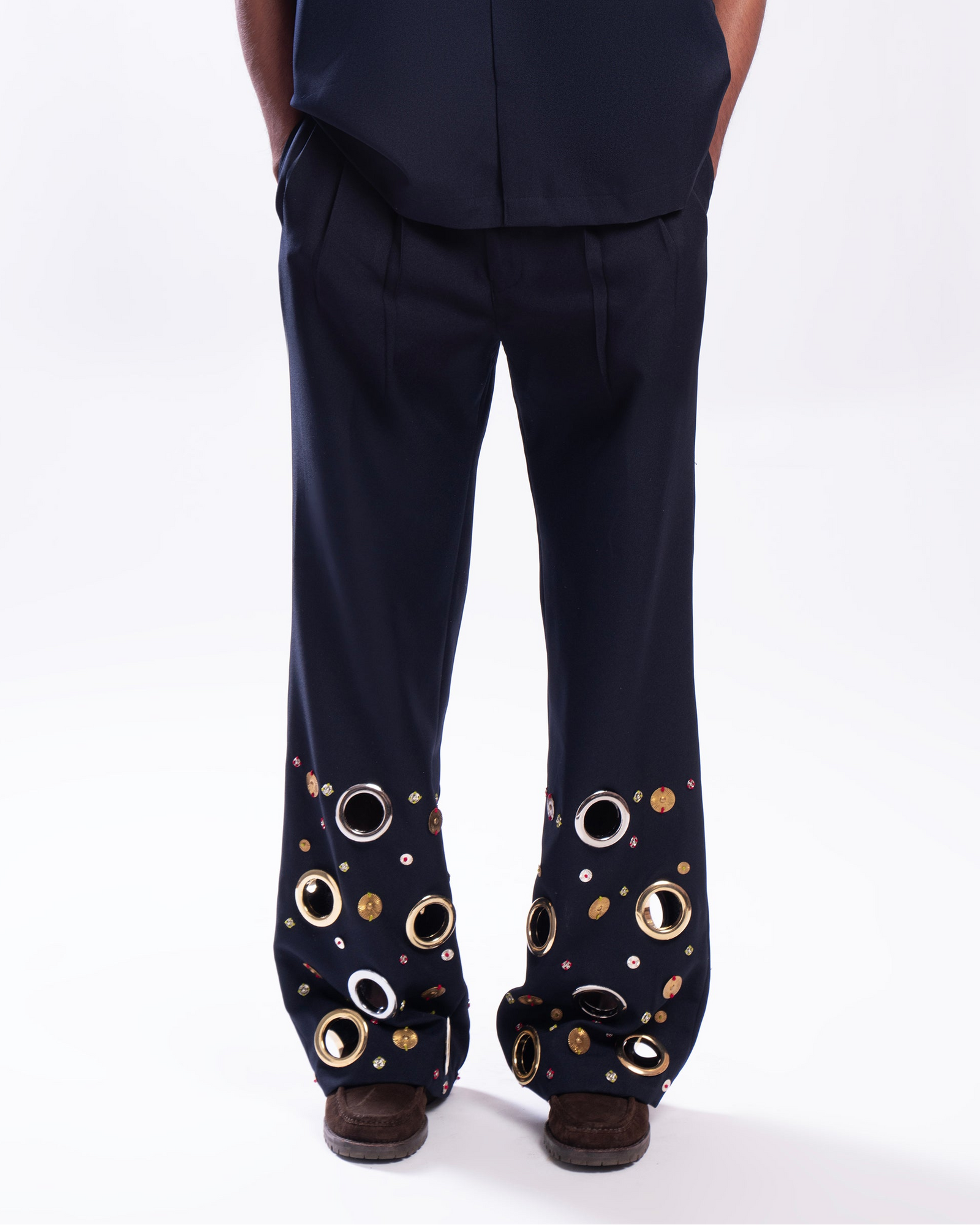 ROSANI The Aryom trouser in blue, front view. Wide-leg with metallic ring embellishment. DYMENSION collection.