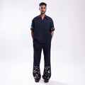 ROSANI The Aryom trouser in blue, full-front view showing wide-leg silhouette and double pleat construction.