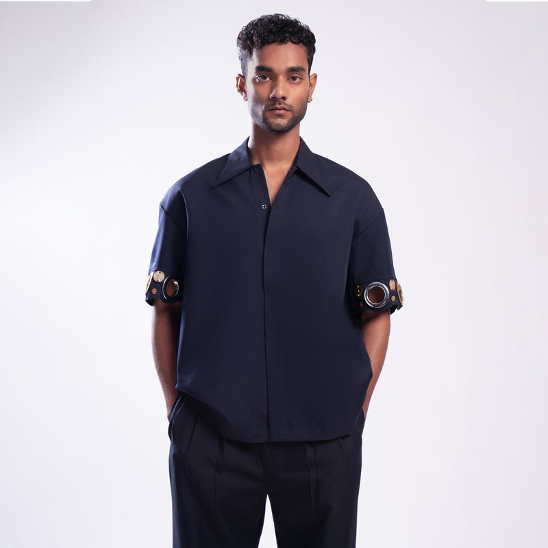 ROSANI The Alti shirt in navy. Box-fit short-sleeve with concealed placket and metallic ring sleeve accents. Front view.