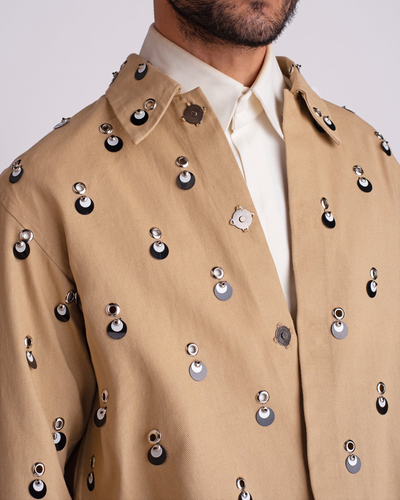 ROSANI The Carter jacket in khaki. Close-up of metallic eyelet and sequin embellishment detail.