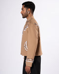 ROSANI The Darby jacket in khaki. Side view showing full embellishment and silhouette. ANIMA and ANIMUS collection.