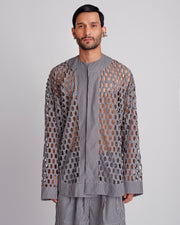 ROSANI The Emerson shirt in black and white stripes. Oversized laser-cut workwear shirt with metallic press buttons and geometric cut-out pattern. ANIMA and ANIMUS collection, front view.