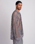 ROSANI The Emerson shirt in black and white stripes. Side view showing oversized silhouette and cut-out pattern.