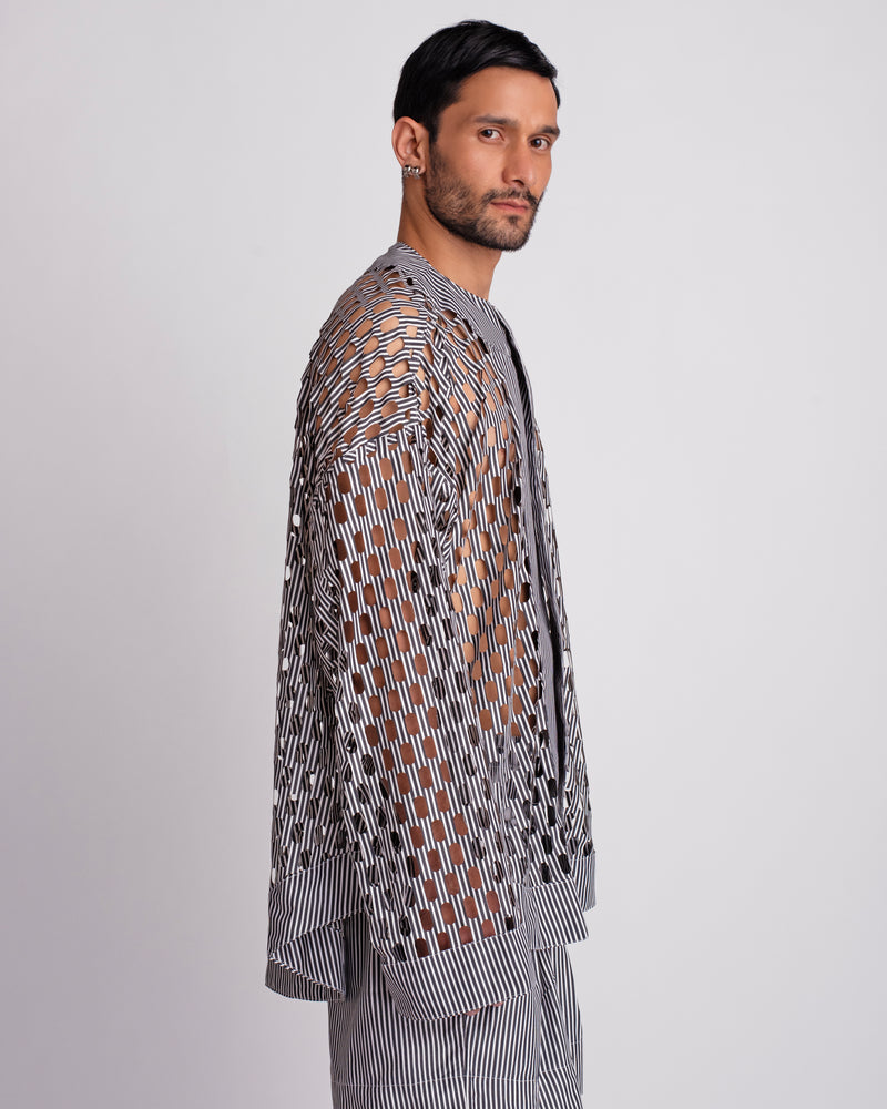 ROSANI The Emerson shirt in black and white stripes. Side view showing oversized silhouette and cut-out pattern.