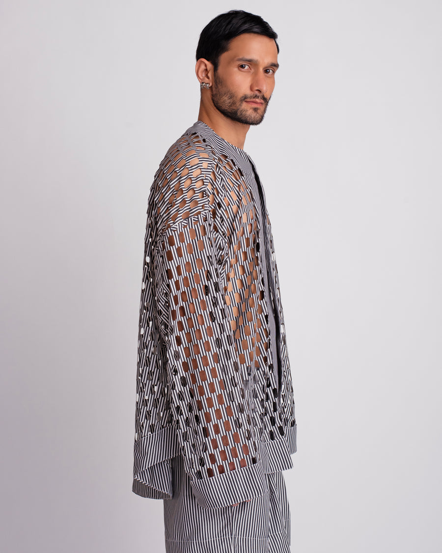 ROSANI The Emerson shirt in black and white stripes. Side view showing oversized silhouette and cut-out pattern.