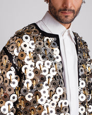 ROSANI The Jase jacket in black and silver. Close-up of metallic disc, bead and cylindrical pipe embroidery detail.