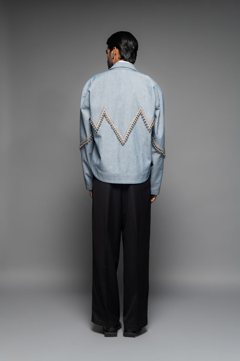 ROSANI The Munzwa jacket in denim blue - oversized unlined denim jacket with zigzag metal embellishment and front button closure, back view