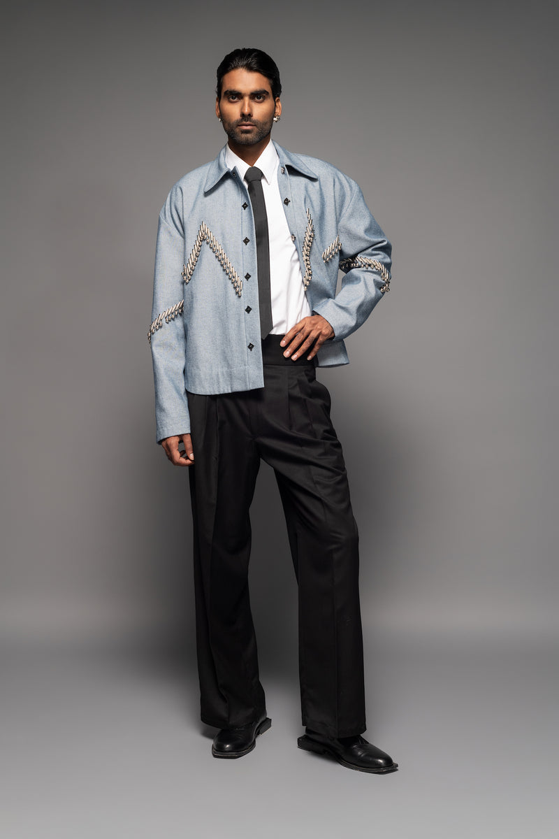 ROSANI The Munzwa jacket in denim blue - oversized unlined denim jacket with zigzag metal embellishment and front button closure, front view