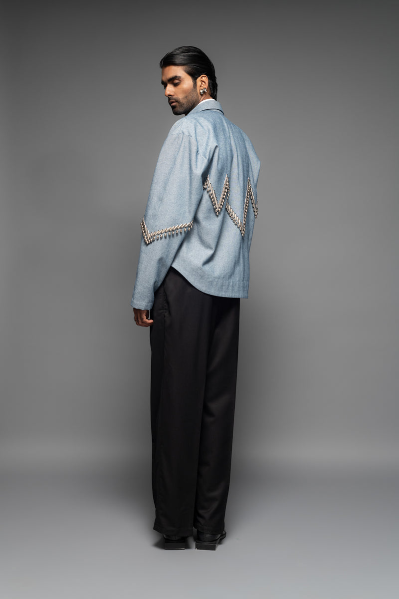 ROSANI The Munzwa jacket in denim blue - oversized unlined denim jacket with zigzag metal embellishment and front button closure, side back view