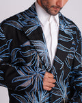 ROSANI The Noah coat in black. Close-up of hand cutwork, thread embroidery and hanging glass rod detail.