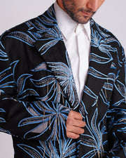 ROSANI The Noah coat in black. Close-up of hand cutwork, thread embroidery and hanging glass rod detail.