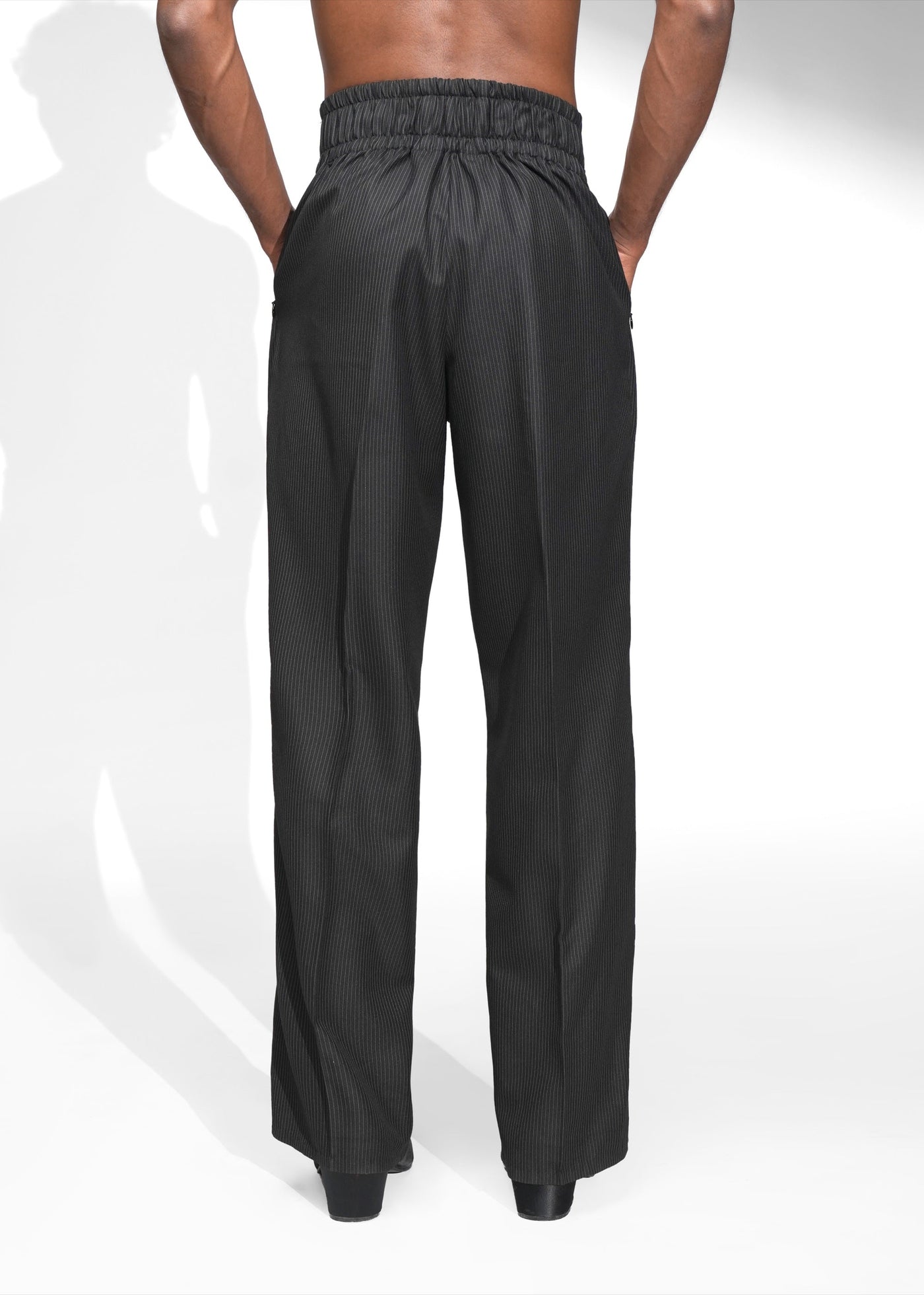 ROSANI The Pulse trouser in black - high waistband pleated trousers, back view showing elastic waistband
