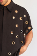 ROSANI The Le Franc shirt, close-up detail of all-over metal eyelet embellishment on cotton.