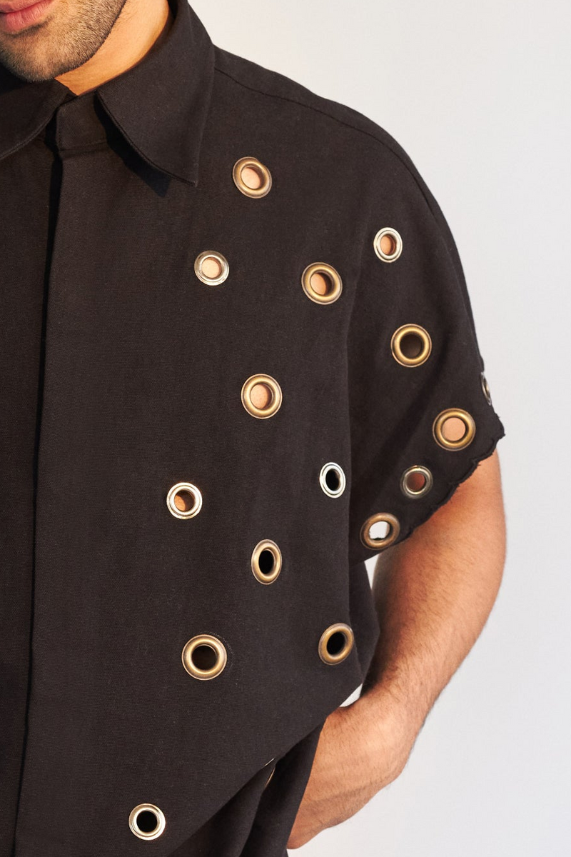 ROSANI The Le Franc shirt, close-up detail of all-over metal eyelet embellishment on cotton.