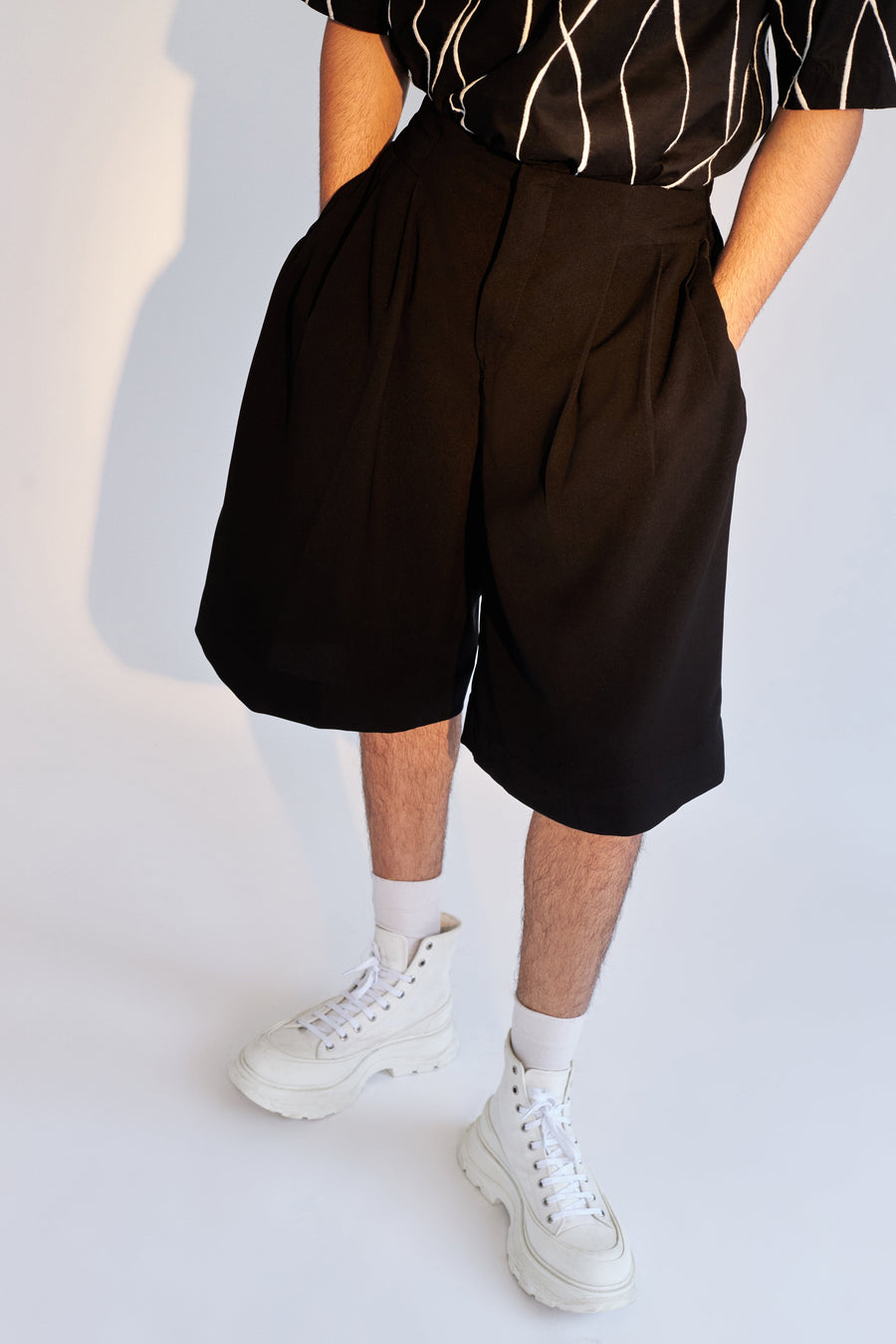 ROSANI The Le Huma short, front view. Relaxed-fit black construction with elasticated waist. DYMENSION collection.