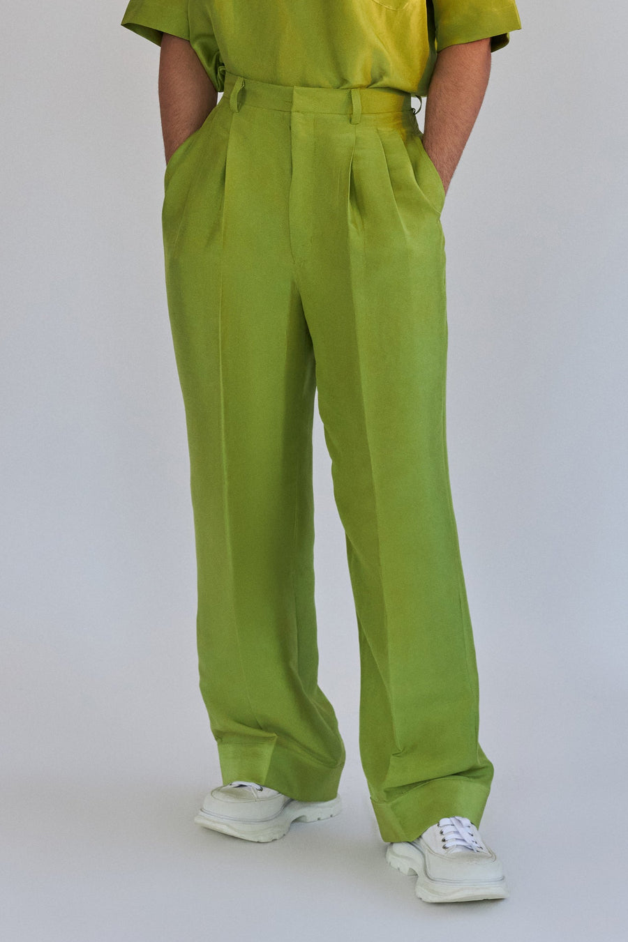 ROSANI The Theo trouser in chartreuse, front view. Wide-leg silk with front pleats. DYMENSION collection.