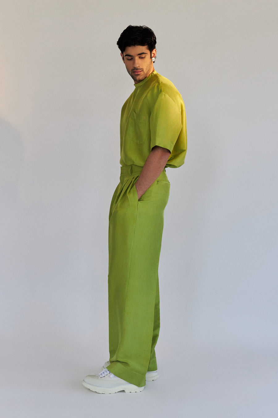 ROSANI The Theo trouser in chartreuse, three-quarter view. Front pleat construction.