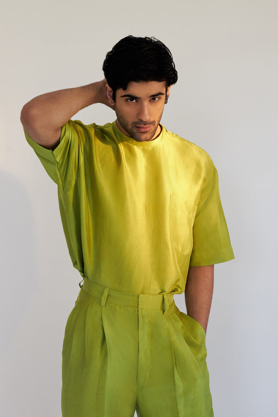 ROSANI The Anto t-shirt in chartreuse, front view. Pure silk with chest pocket and signature shoulder zip. DYMENSION collection.
