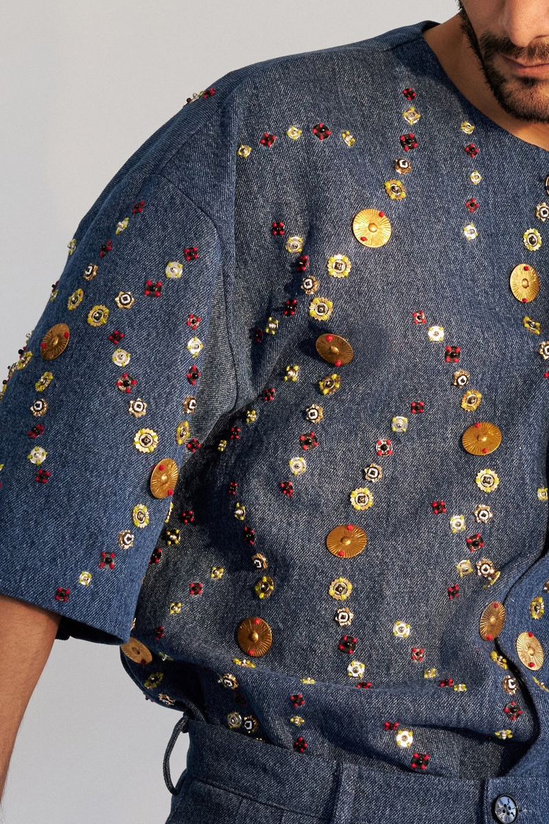 ROSANI The Atto shirt, close-up detail of overlapping metallic discs and mixed bead embroidery on denim.