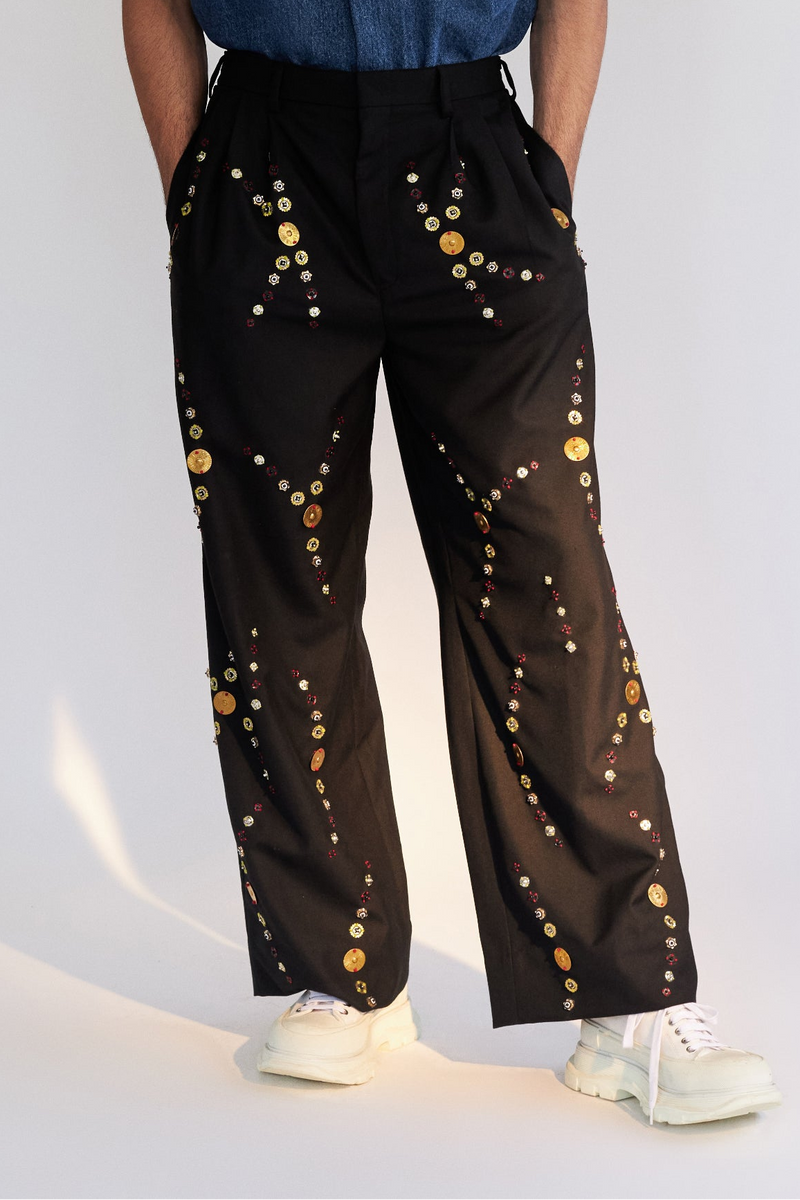 ROSANI The Orto trouser, front view. Wide-leg black with scattered metallic hand embroidery. DYMENSION collection.